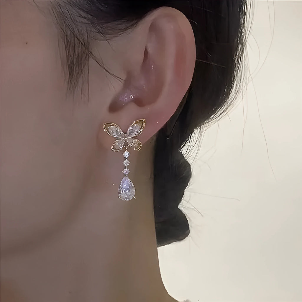 Bow-shaped zinc alloy stud earrings with electroplated platinum finish