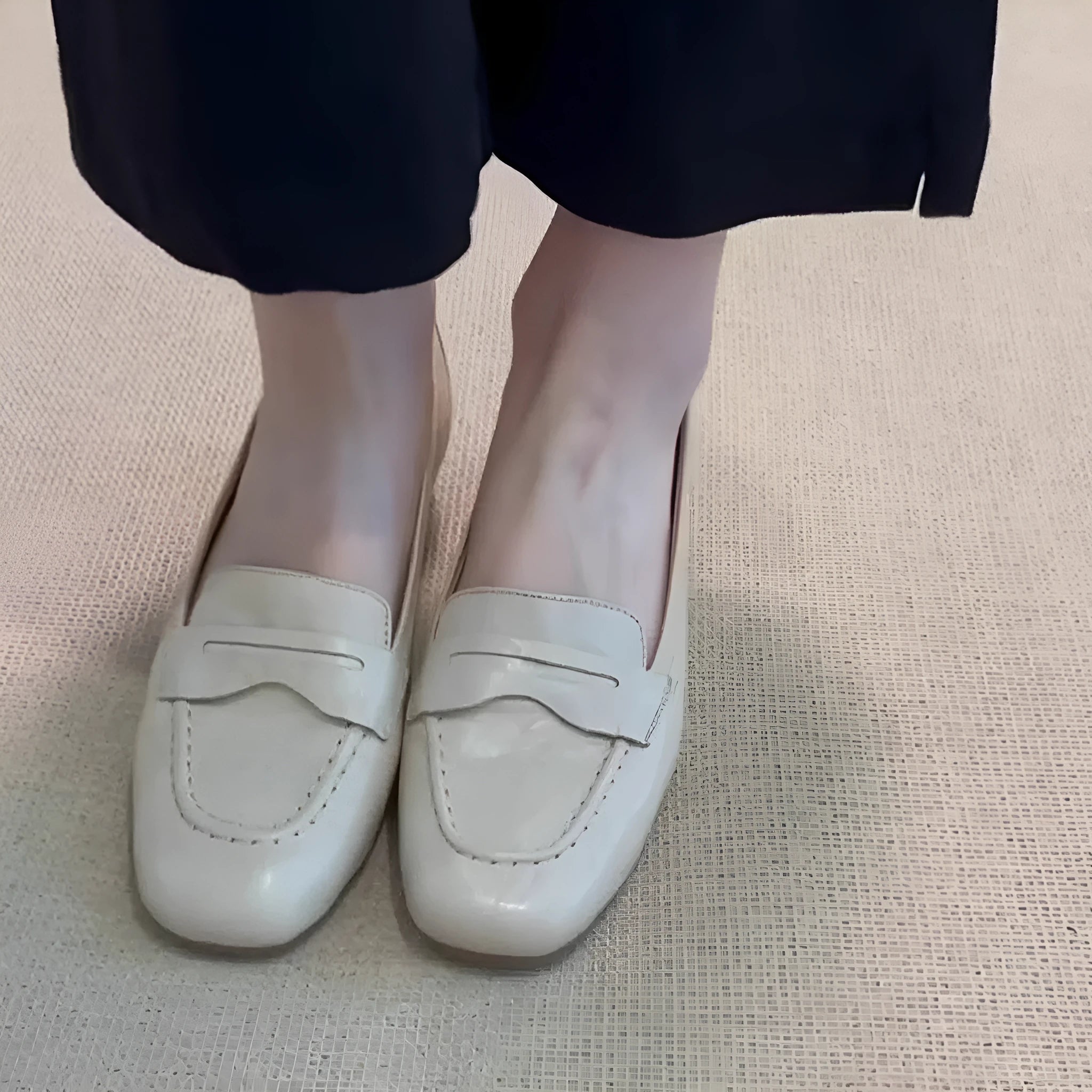 Beige white women's square toe flat shoes with cowhide upper and low heel on a plain background