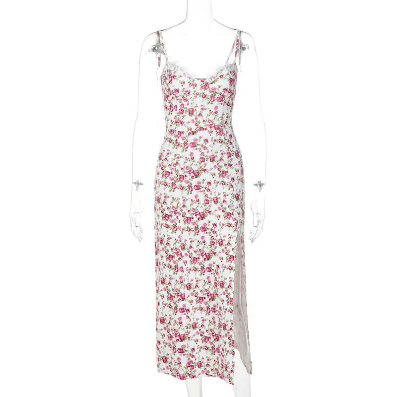 Women's blue lace flowers print long dress with suspender straps and a side slit on a model.