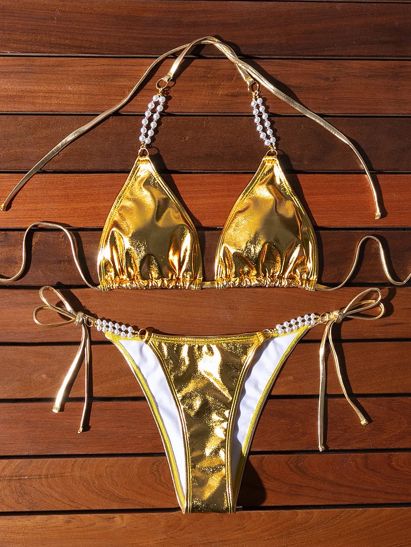 Gold halter lace-up bikini swimsuit with pearl chain fastening on the back