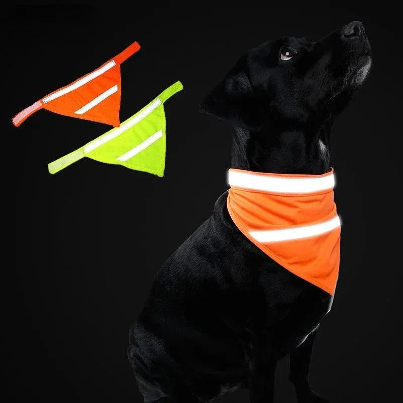 Yellow and orange reflective dog bandana scarf with adhesive fastening strap laid flat.