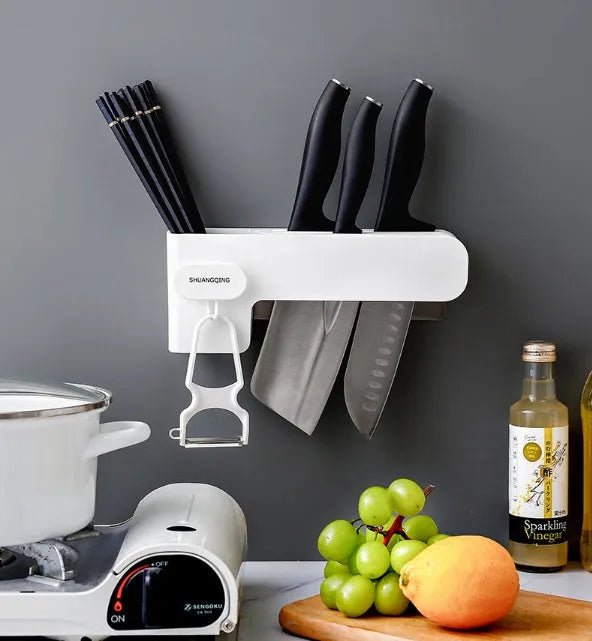 White plastic freestanding kitchen knife rack on a countertop.
