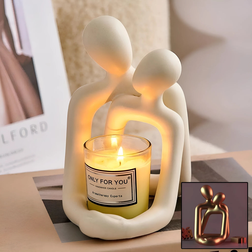 Modern milky white loving couple resin statue on a wooden shelf.