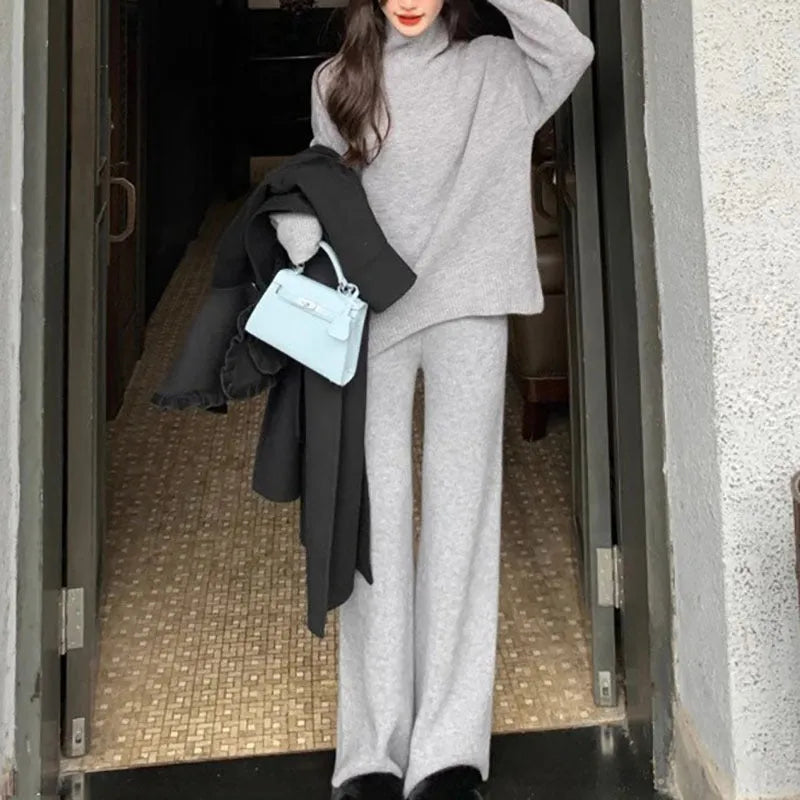Women's beige acrylic sweater and wide-leg trousers casual two-piece set on a hanger.
