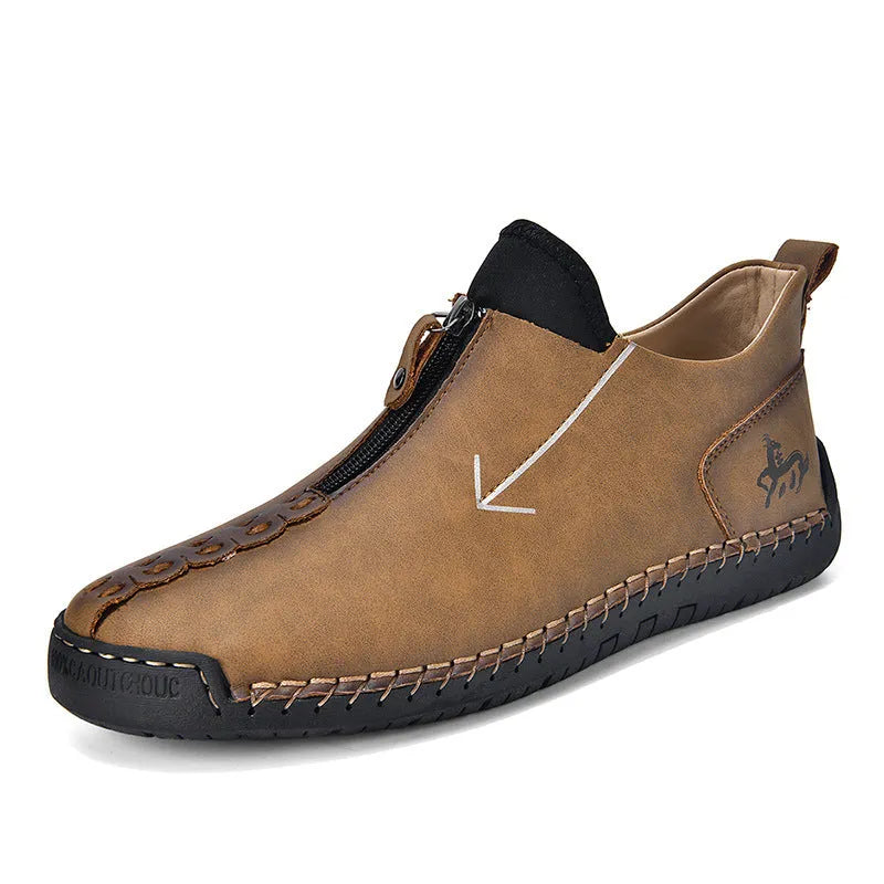 Men's black leather zip-up martin boots with round toe and low heel on a rubber sole.