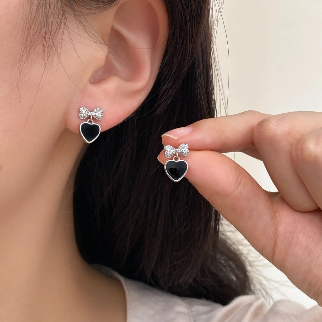 Pair of women's copper earrings, one heart-shaped and one bow-shaped, with micro-set zircon stones, ear clip and ear stud options