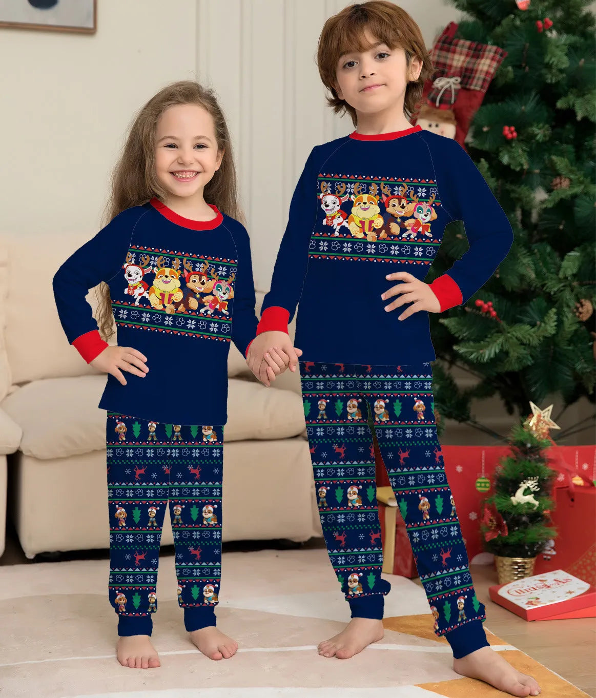 Family wearing matching red deer plaid Christmas pyjamas with adults, children, baby, and dog