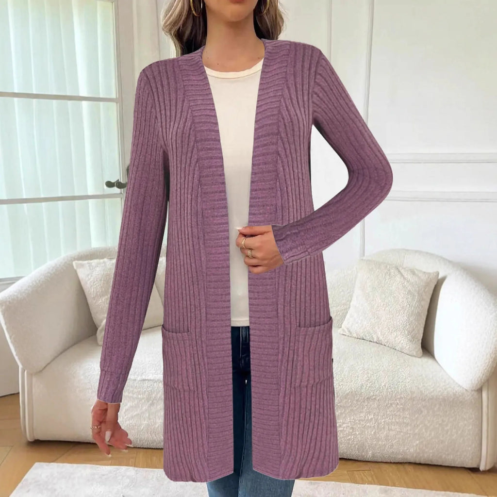 Long sleeve loose knitted cardigan jacket in black, shown with side pockets.