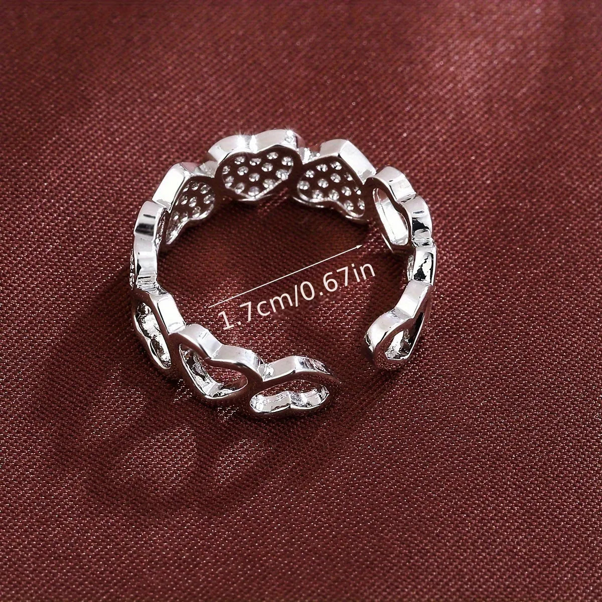 Adjustable copper fashion ring with a heart design, shown in gold and silver colour options.