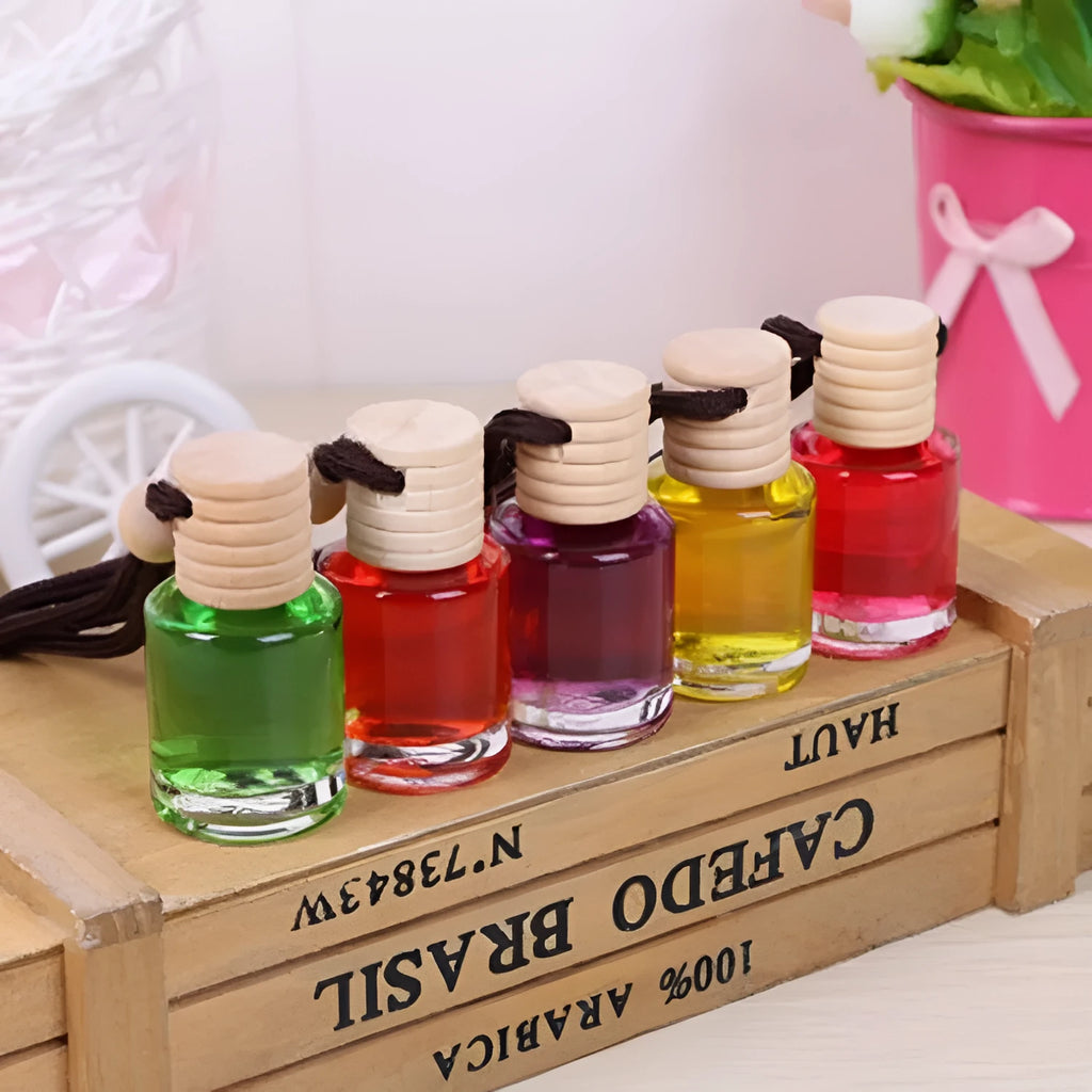 Car air freshener glass bottle hanging ornament showing scent options: Lavender, Lemon, Apple, Strawberry, Ocean, Floral.