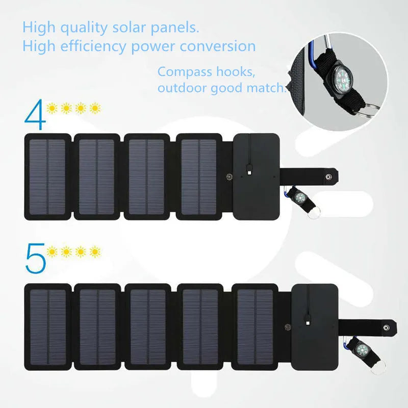 Black folding solar panel charger with monocrystalline cells and USB output, folded flat on a wooden surface, compass buckle visible