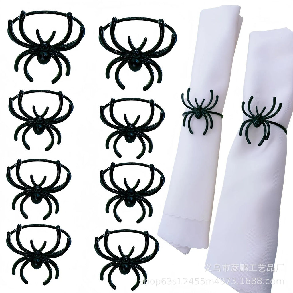 Six black metal spider-shaped napkin rings for Halloween table decoration.