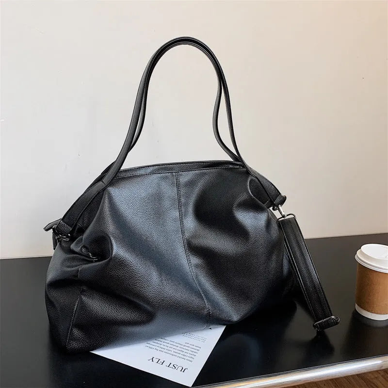 Large soft surface messenger bag in black with adjustable shoulder strap and zip opening
