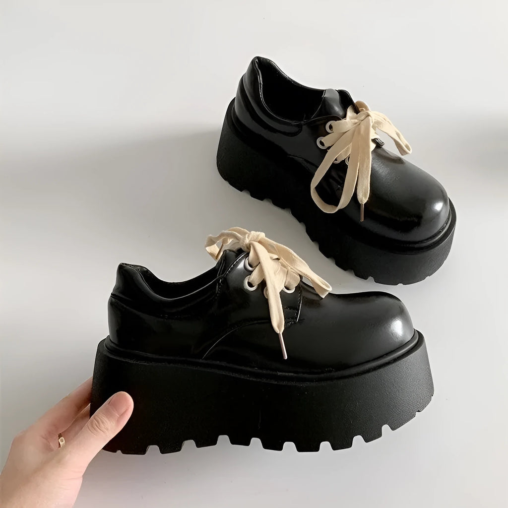 Women's black matte PU leather chunky platform shoes with lace-up buckle and round toe.
