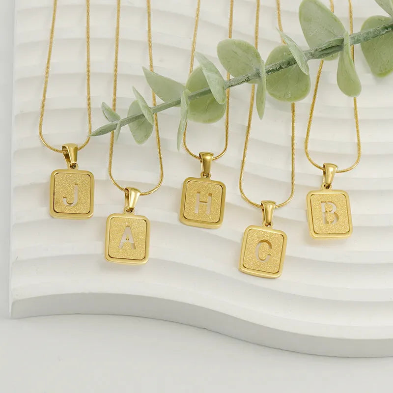 Alphabet necklace with square hollow-out letter pendant in titanium steel, gold or silver electroplated small snake chain