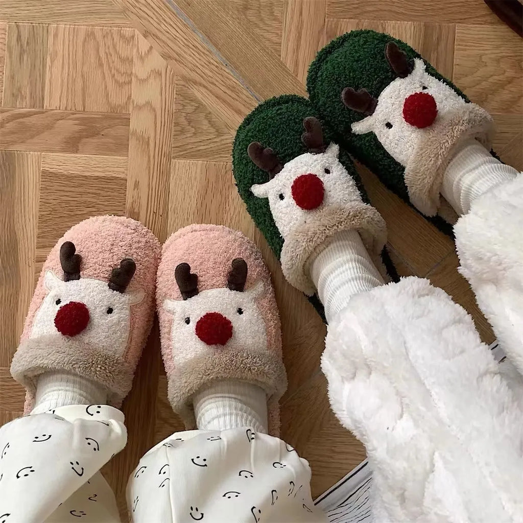 Women's Christmas deer patterned cotton slippers with anti-slip soles in brown, pink and green colours.
