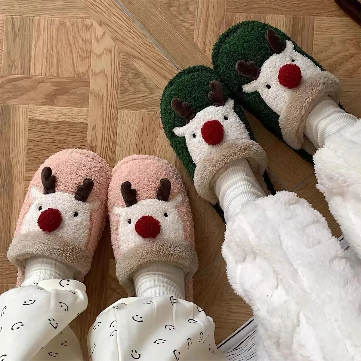 Women's Christmas deer patterned cotton slippers with anti-slip soles in brown, pink and green colours.