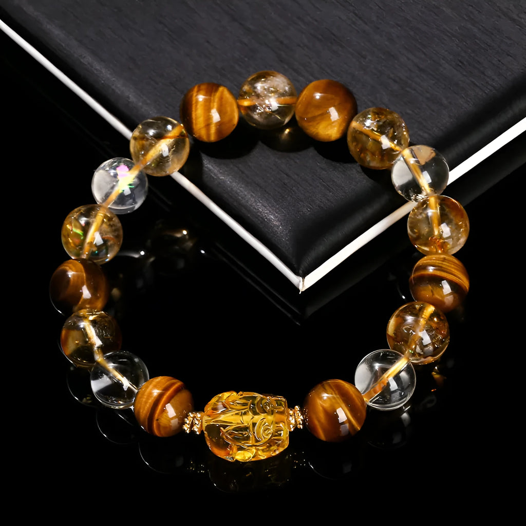 Natural yellow tiger's eye and citrine bracelet with 10mm round beads and a silver pi xiu charm on a wrist.