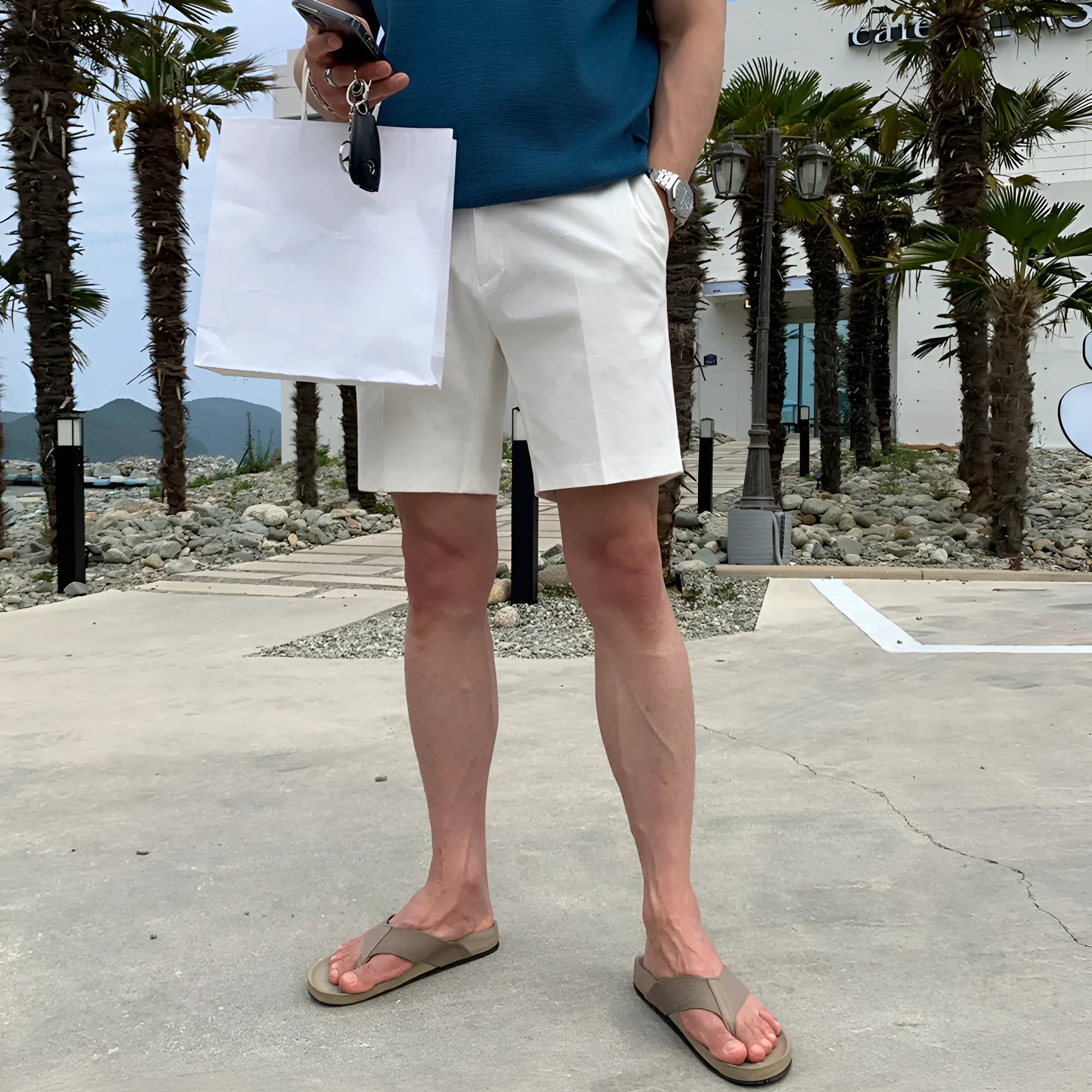 Men's straight leg casual shorts in non-ironing polyester fabric available in black, white, and khaki colours