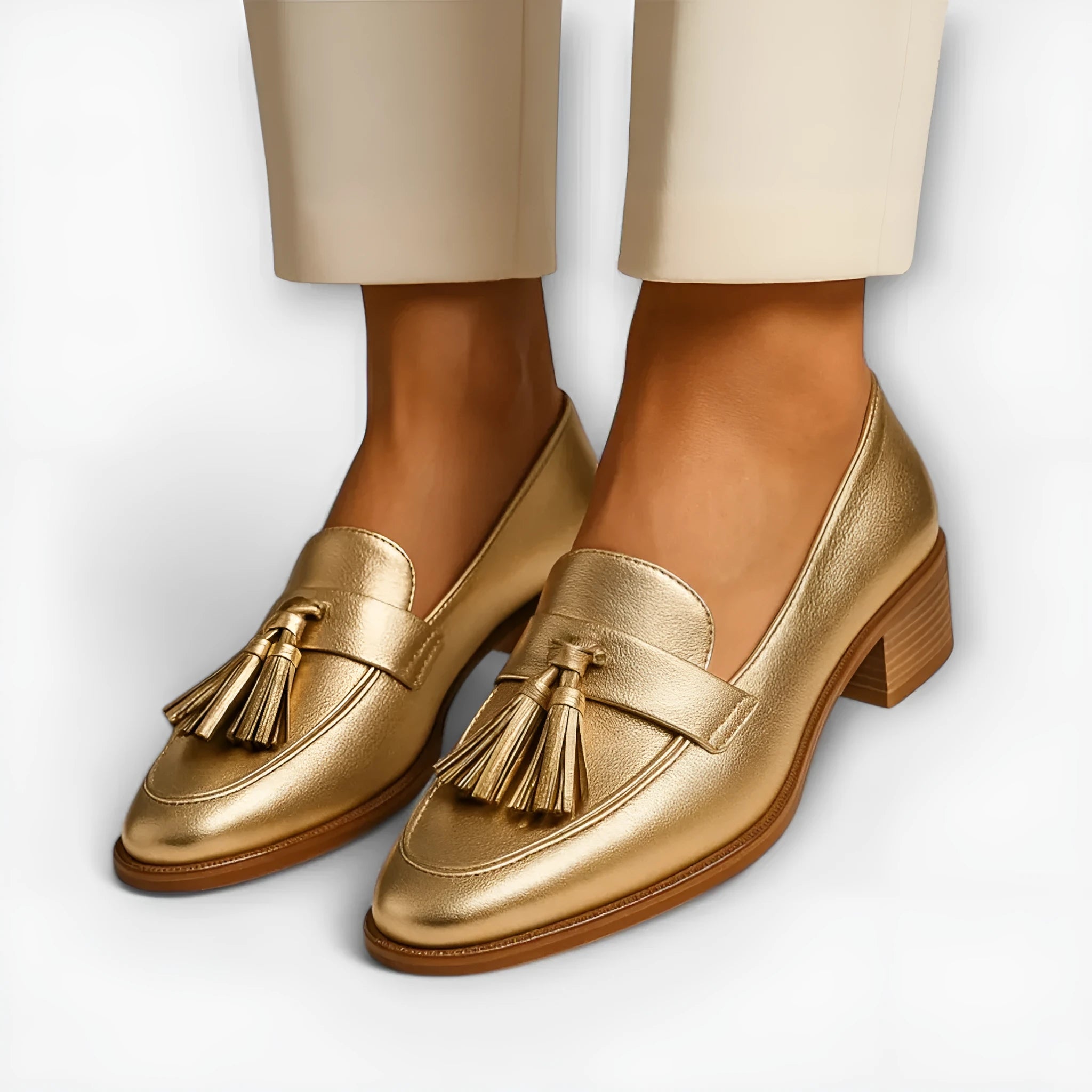 Gold PU leather low heel slip-on pumps with tassel detail and square toe on woman's feet