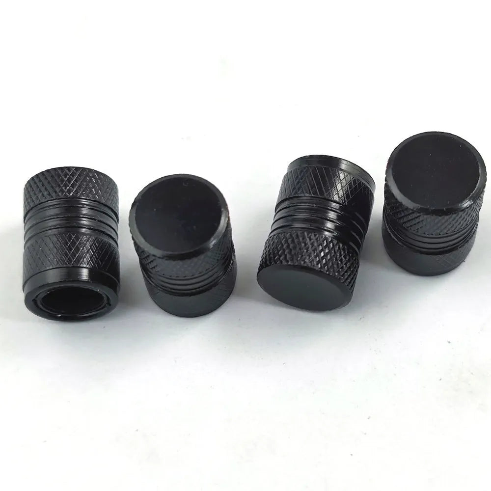 Aluminium car tyre valve cover in black, 17mm length, on a tyre valve stem