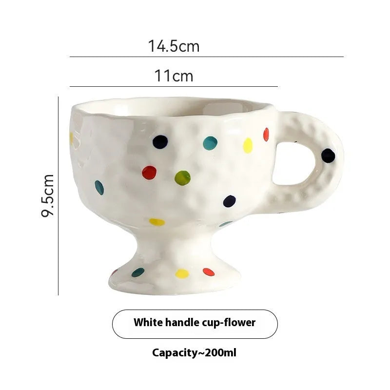 Hand-pinched irregular ceramic mug in a solid colour, showing its unique shape.