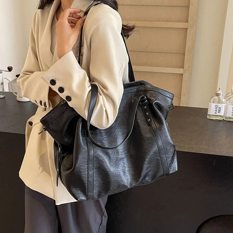 Retro soft PU leather messenger bag in black with horizontal square shape and sewing thread detail