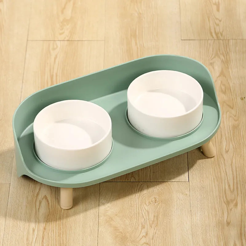 Green adjustable tilted pet feeder with two bowls for cats and dogs