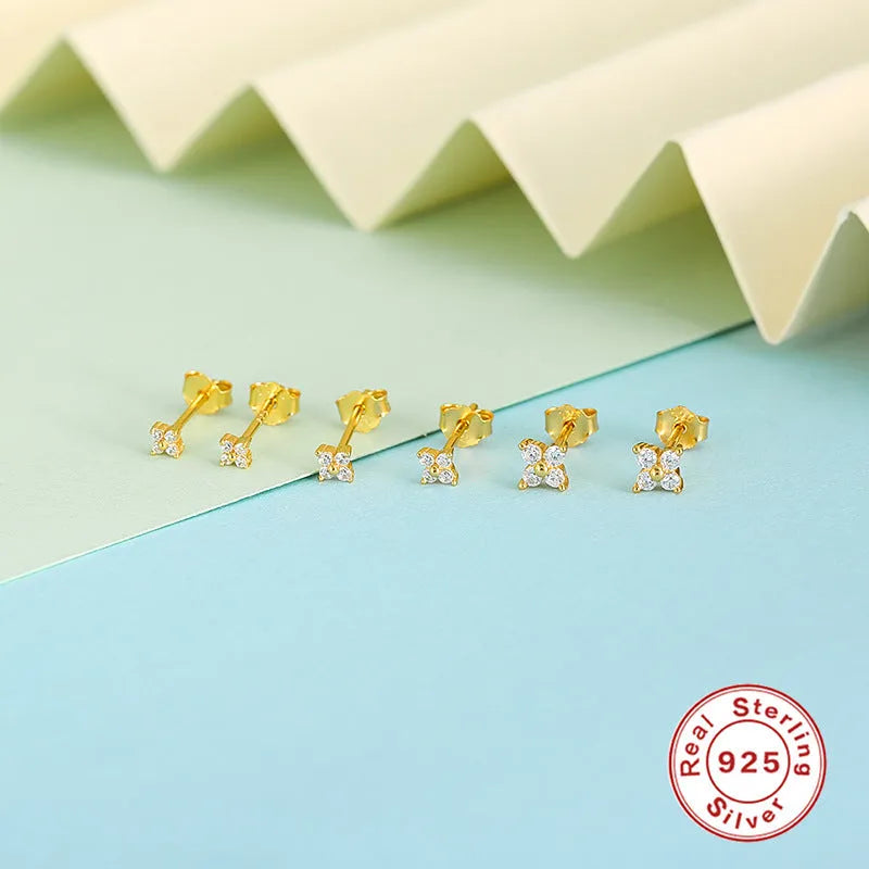 S925 sterling silver stud earrings with geometric flower petal and crystal design in gold and platinum finishes.