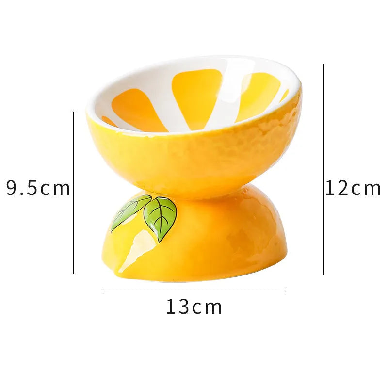 Ceramic elevated cat bowl with tilted wide dish in a colourful fruit pattern.