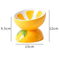 Ceramic elevated cat bowl with tilted wide dish in a colourful fruit pattern.