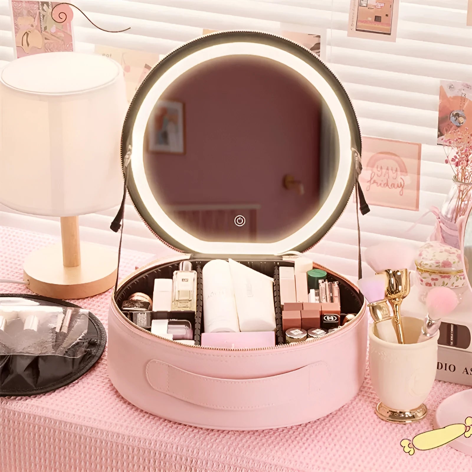 Round pink PU leather makeup bag with LED mirror open, showing internal partitions and carry strap.