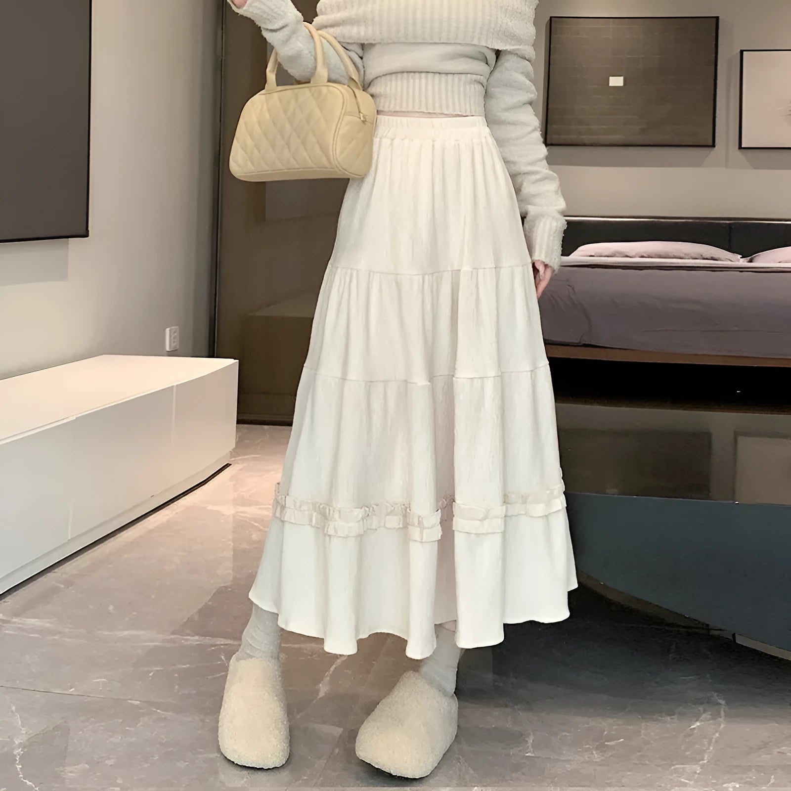 Beige corduroy A-line midi skirt with an elasticated waistband on a hanger.