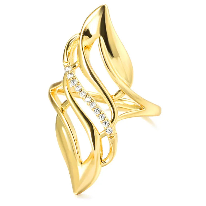 Women's gold-colour ring with exaggerated curved design on finger, showing profile and zircon finish