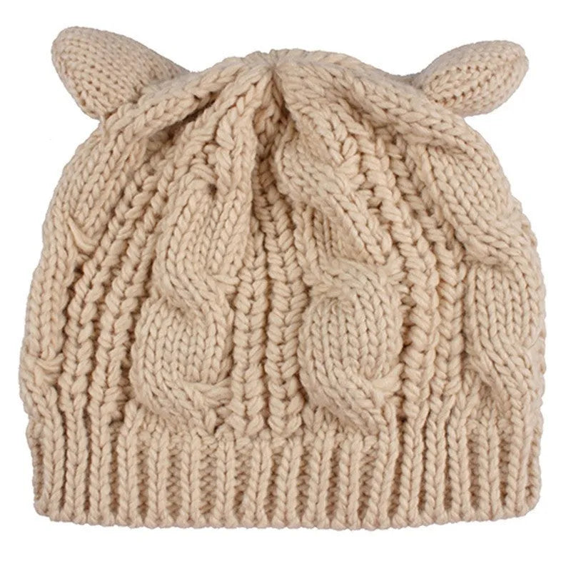 Hand-made red knitted winter beanie with 3D cat ears on a mannequin head.