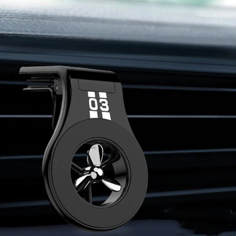 Black magnetic car phone holder mounted on vehicle air vent with smartphone attached