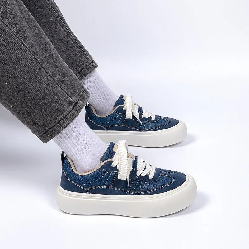 Men's black canvas platform lace-up trainers with a raised heel on a white background