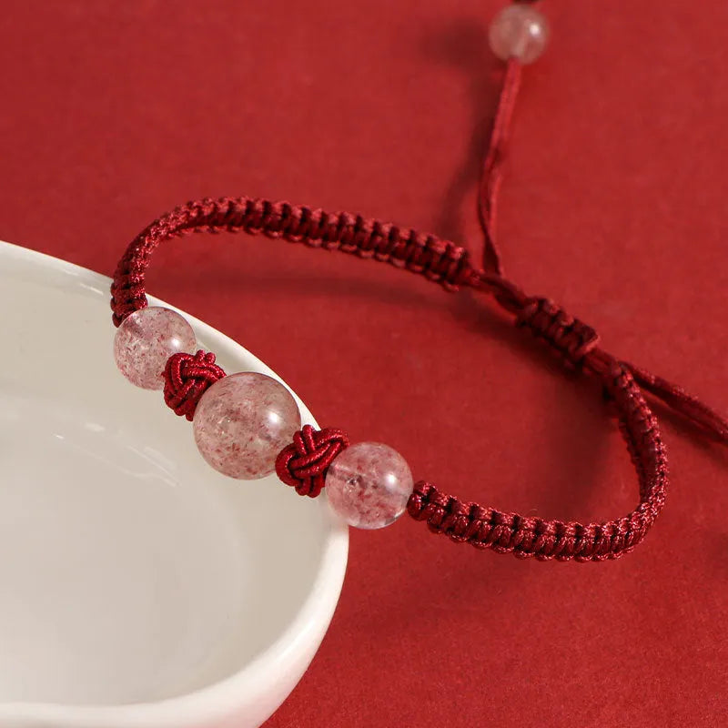 Woven red rope bracelet with spherical strawberry quartz beads and alloy clasp