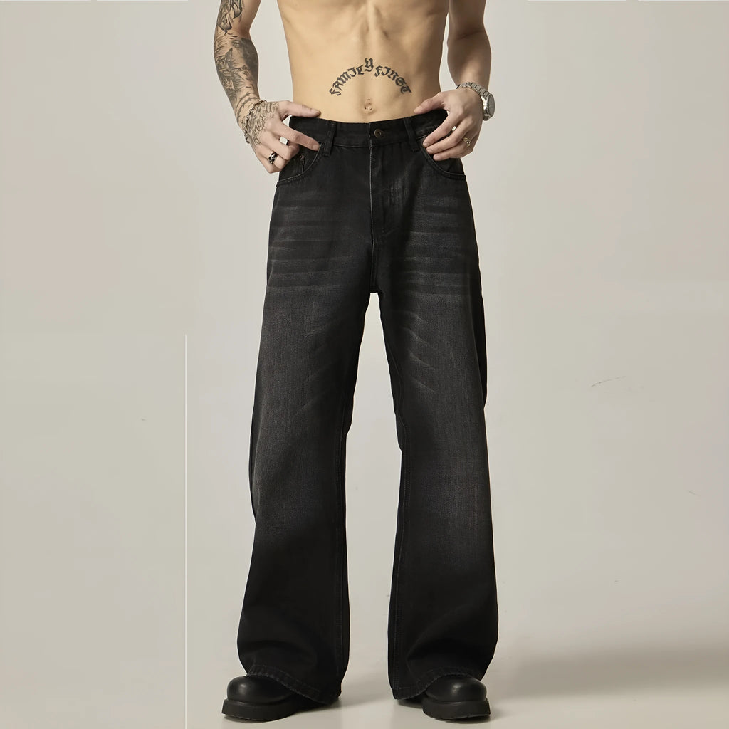 Black loose-fit straight-leg retro jeans with zipper fly on a plain background.
