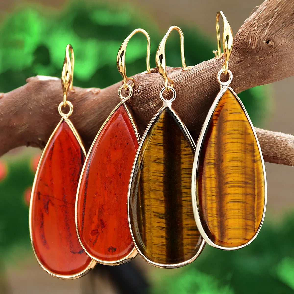 Vintage long water drop earrings in tigereye stone with textured surface and dangle silhouette