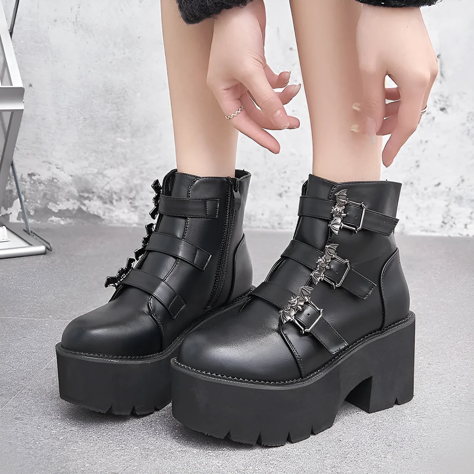 Black women's punk gothic short ankle boots with a bat buckle and side zip.
