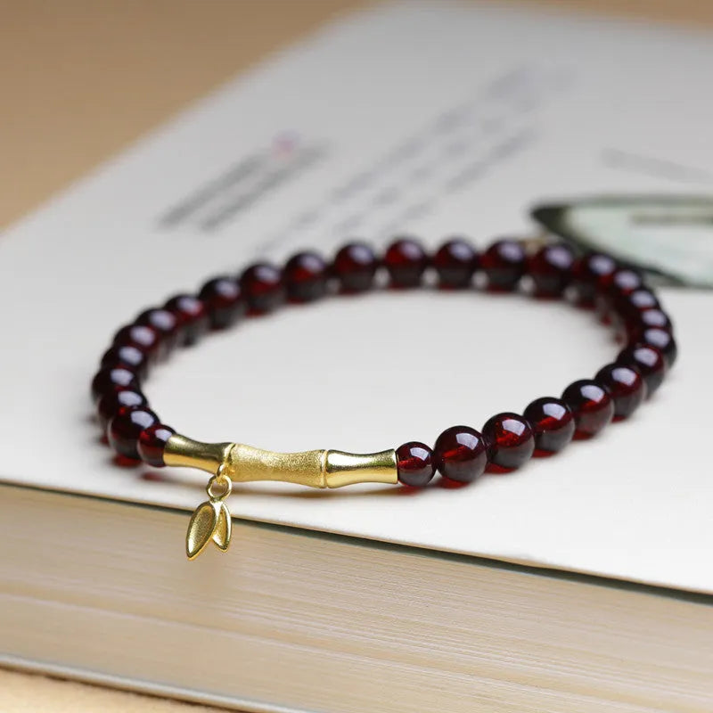 Natural garnet stone set in a 6mm bamboo joint ring bracelet with copper or silver finish.