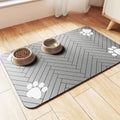Diatomite pet feeding mat in blue placed under a dog's food and water bowls.