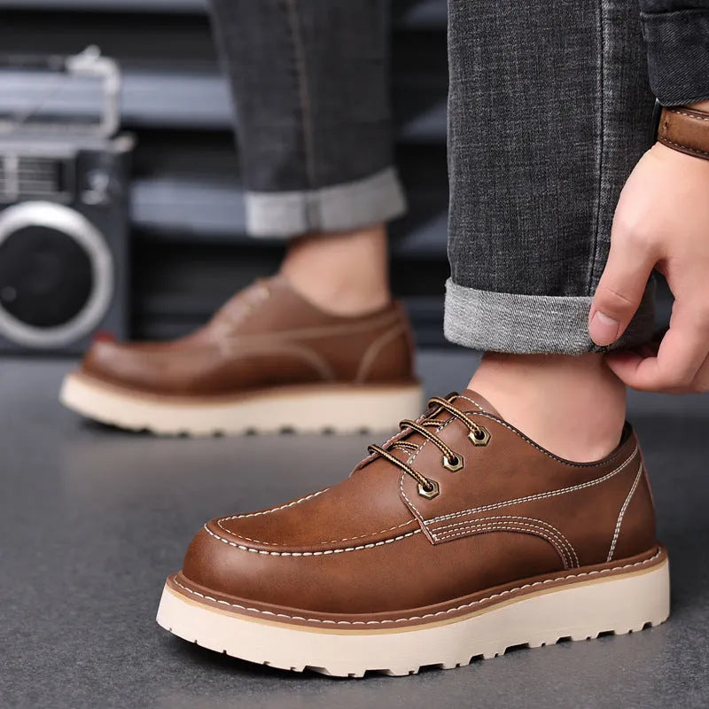 Men's black retro low-top Martin boots with a round toe and rubber sole on a white background