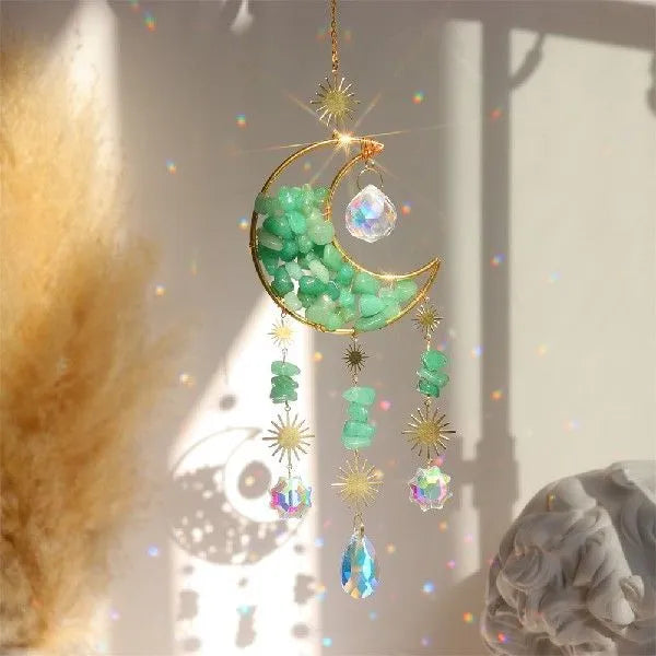 K9 crystal moon-shaped pendant on a cord for hanging in a car interior.