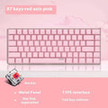 Compact white-backlit mechanical keyboard with 82 keys and metal body next to a laptop.