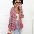 Rose red loose fit knitted cardigan coat with rainbow coloured stripes, shown on a model.