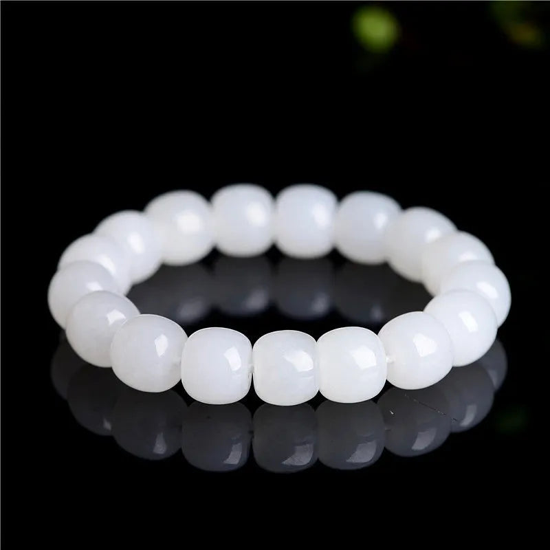 White Hetian jade barrel bead bracelet for men and women, shown in a casual style.