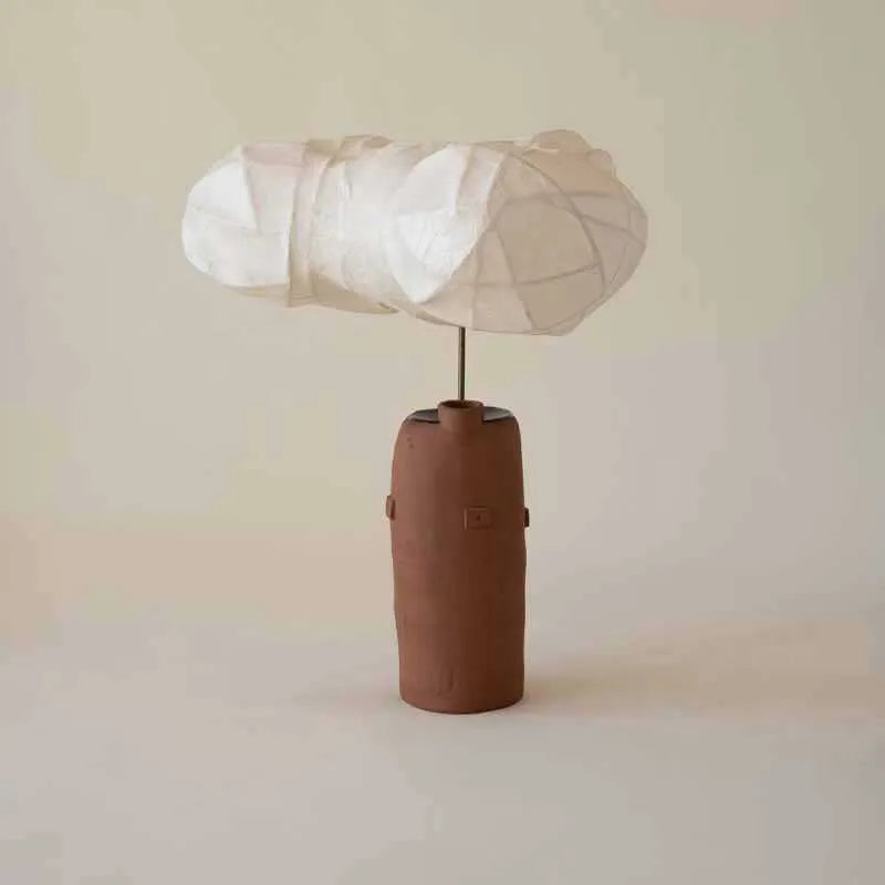 Retro modern table lamp with metal base and fabric shade on a wooden desk