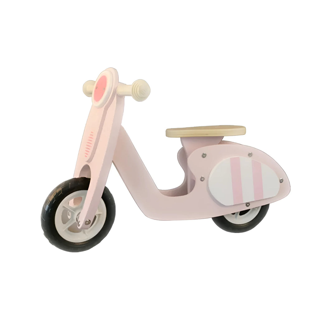 Pink wooden balance scooter for toddlers, 10 inches in size, on a flat surface.